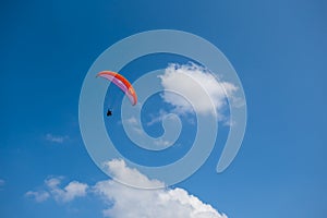 Paraglider fly among a blue sky