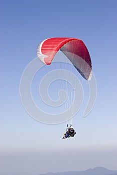 Red paraglider with two person