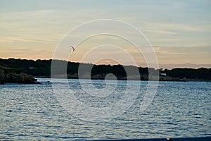 Red paramotor in the evening sky