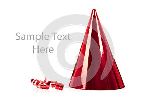 A red party hat and streamer on white