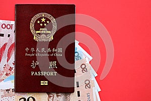 Red passport of People Republic of China and chinese yuan money bills. PRC chinese passport