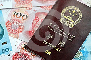 Red passport of People Republic of China and chinese yuan money bills. PRC chinese passport