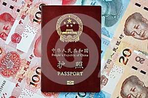 Red passport of People Republic of China and chinese yuan money bills. PRC chinese passport