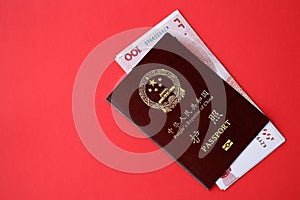 Red passport of People Republic of China and chinese yuan money bills. PRC chinese passport