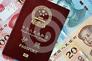 Red passport of People Republic of China and chinese yuan money bills. PRC chinese passport