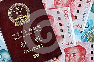 Red passport of People Republic of China and chinese yuan money bills. PRC chinese passport