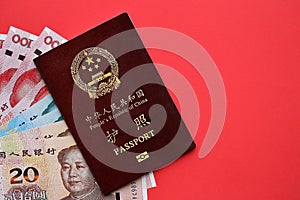 Red passport of People Republic of China and chinese yuan money bills. PRC chinese passport