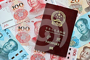 Red passport of People Republic of China and chinese yuan money bills. PRC chinese passport