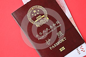 Red passport of People Republic of China and chinese yuan money bills. PRC chinese passport