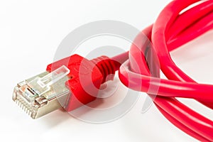 Red patch cable with RJ45 connector isolated on white background