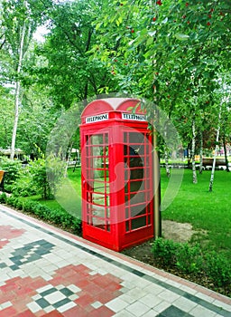Red payphone booth in the English style in Gorky Park. Melitopol