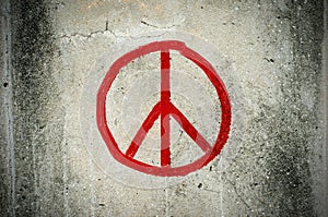Red peace symbol graffiti on grunge ciment wall photo