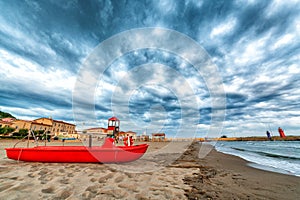 Red pedal boat on a beautiful beach at dusk