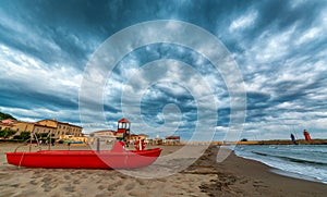 Red pedal boat on a beautiful beach at dusk