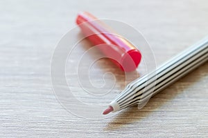 A red pen chemical permanence is opening a cap