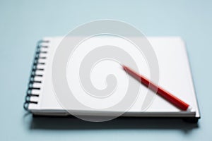 Red pen notebook in blur