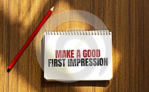 Red pen and notepad with text Make a good first impression in the white background