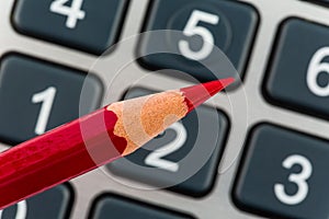 Red pencil and calculator