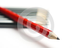 Red pencil crossing grey group diagonally
