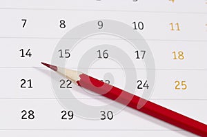 Red pencil over calendar