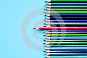 Red pencil standing out on blue background. Leadership, uniqueness, independence, initiative, strategy, dissent, think different,