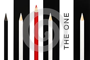 Red pencil standing out from crowd of black and white fellows on bw stripe background. business success concept of leadership