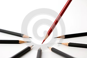 Red pencil standing out from crowd of plenty identical black fellows business success concept.