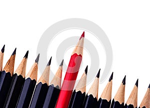 Red pencil standing out from crowd of plenty identical black fellows on white background. business success concept