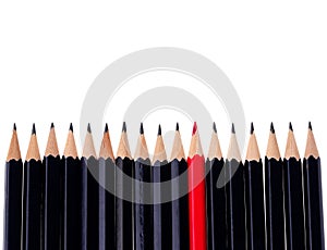 Red pencil standing out from crowd of plenty identical black fellows on white background. business success concept