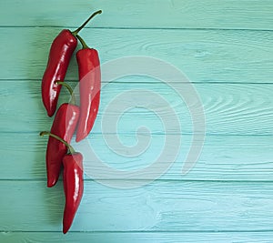 Red pepper on a blue wooden background cayenne spice