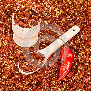 Red pepper or cayenne pepper crushed with flakes scattered photo