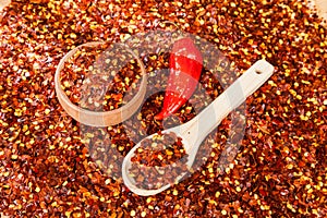 Red pepper or cayenne pepper crushed with flakes scattered