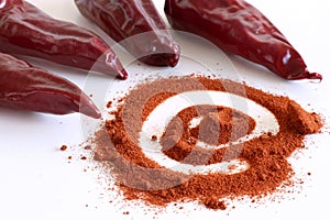 Red pepper chili Piment d`espelette and pile of red powder isolated on white background.Food concept.