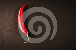 red pepper on a dark stone background/red hot pepper on a dark stone background. Top view. Copy space