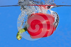 Red pepper dropped in water.