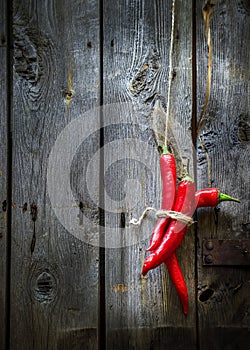 Red pepper on old wooden background.