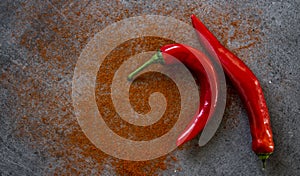 Red pepper and paprika powder on a table flat lay