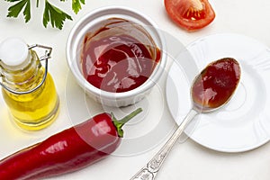 Red pepper pod, tomato wedge and olive oil. Spoon with tomato sauce