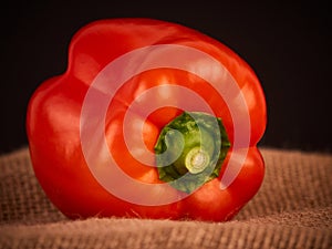 A red pepper with a rustic background