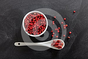 Red pepper spice seeds in porcelain bowl and spoon