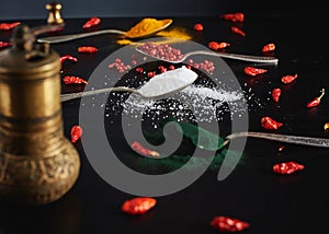 Red pepper  tumeric , chili peper,  white salt and spirulina in vintage spoons on black background of different types of spices in