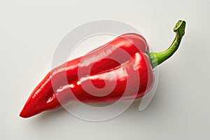 Red Pepper on White Background A bright red pepper rests on a clean white background, showcasing its vibrant color and texture