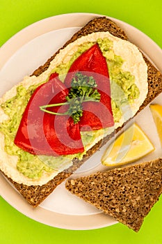Red Peppers With Avocado and Hummus On Rye Open Face Sandwich