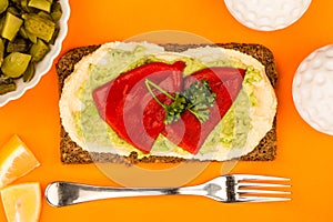 Red Peppers With Avocado and Hummus On Rye Open Face Sandwich