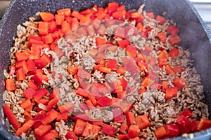 Red peppers being added to minced meat