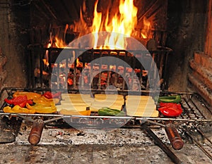 Red peppers grilled in a fireplace