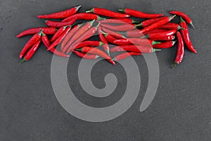 Red peppers on stone background. Free copy space