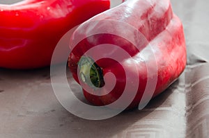Red peppers, on table with brown tablecloth