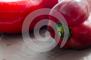 Red peppers, on table with brown tablecloth