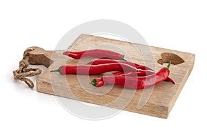 Red peppers on a wooden cutting board